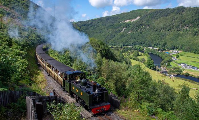 The train climbs along the inside of the Rheidol Valley with a beautiful view of the valley stretching out below.